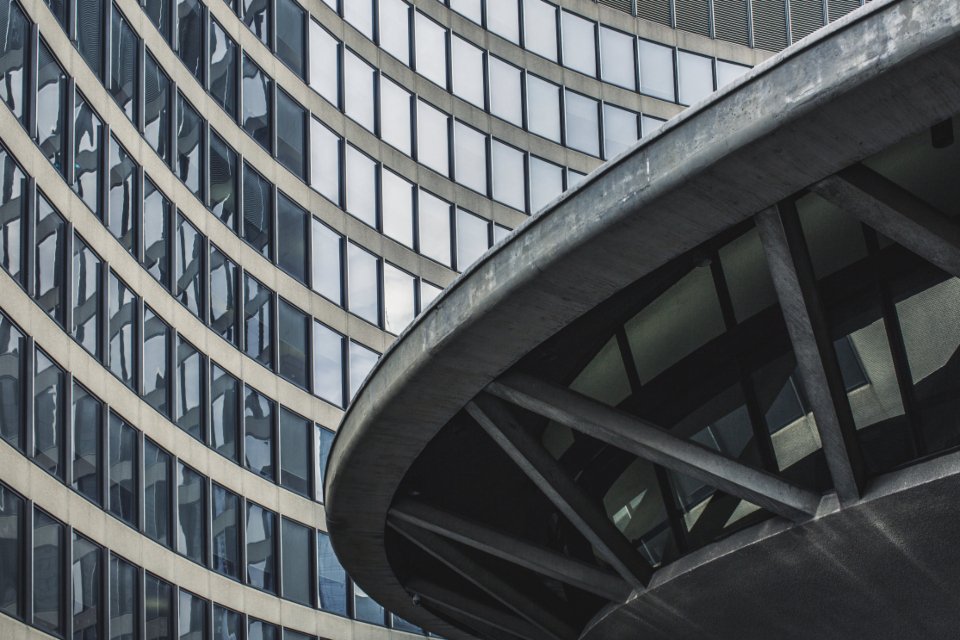 Curved concrete and glass facade of a large institutional building